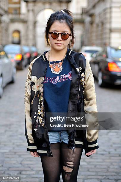 Student Anya poses wearing a Zara jacket, shoes from Marni with unbranded shorts and glasses in Somerset House during London Fashion Week on February...