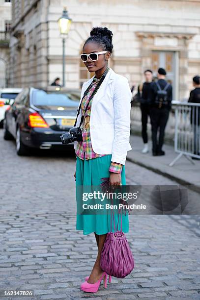 Blogger Cecile poses wearing an ASOS jacket with an unknown t-shirt with shoes and bag from Selfridges and glasses and belt from H+M at Somerset...