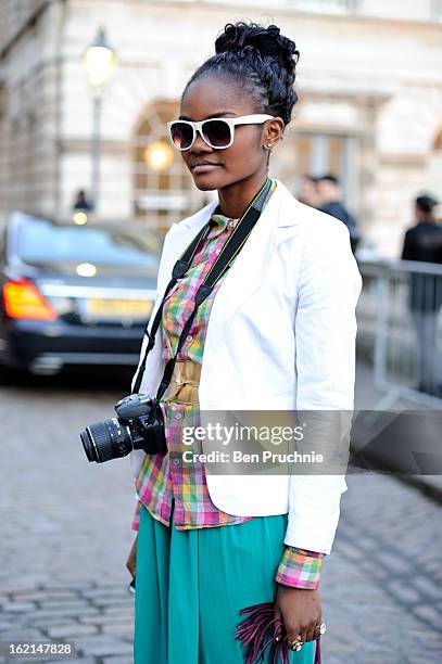 Blogger Cecile poses wearing an ASOS jacket with an unknown t-shirt with shoes and bag from Selfridges and glasses and belt from H+M at Somerset...