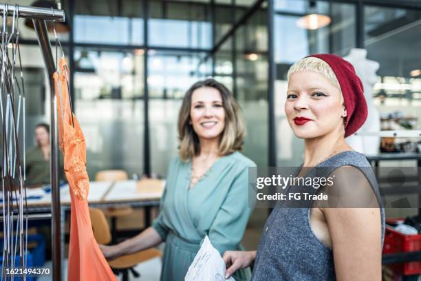 portrait of a young fashion designer at atelier - fashion stylist stock pictures, royalty-free photos & images