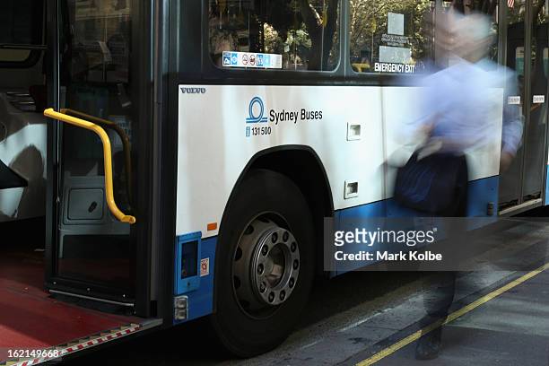 Commuter runs to catch a bus on York street in the CBD on February 19, 2013 in Sydney, Australia. State Transit will be cutting buses on dead routes...