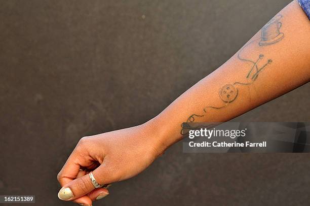 Leona Green revealing a hand with scrolling needle and thread tatoos at London Stylist t, and her own braided hair creation at London Fashion Week...