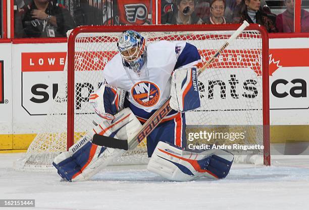 Rick DiPietro the New York Islanders ducks to avoid an eye-level shot by the Ottawa Senators on February 19, 2013 at Scotiabank Place in Ottawa,...