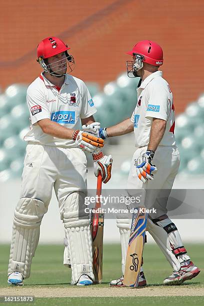 Tim Ludeman of the Redbacks congratulates teammate Jake Brown after Brown scored 50 runs during day two of the Sheffield Shield match between the...