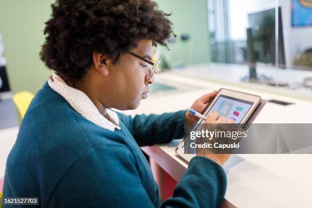 woman working on a design project using a tablet - publicidade stock pictures, royalty-free photos & images