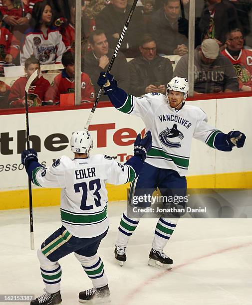 Daniel Sedin of the Vancouver Canucks celebrates his goal against the Chicago Blackhawks with Alexander Edler at the United Center on February 19,...