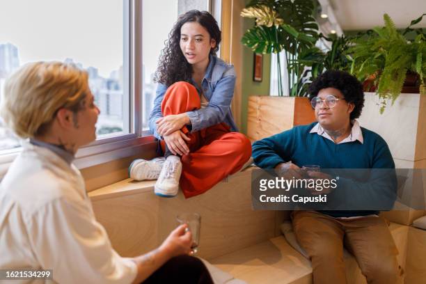 team mates chatting during a coffee break - publicidade stock pictures, royalty-free photos & images