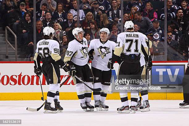 Kris Letang, Sidney Crosby, Chris Kunitz and Evgeni Malkin of the Pittsburgh Penguins celebrate a third period goal against the Winnipeg Jets at the...