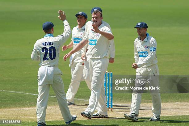 Doug Bollinger of the Blues celebrates with teammates after he got a wicket during day two of the Sheffield Shield match between the South Australian...
