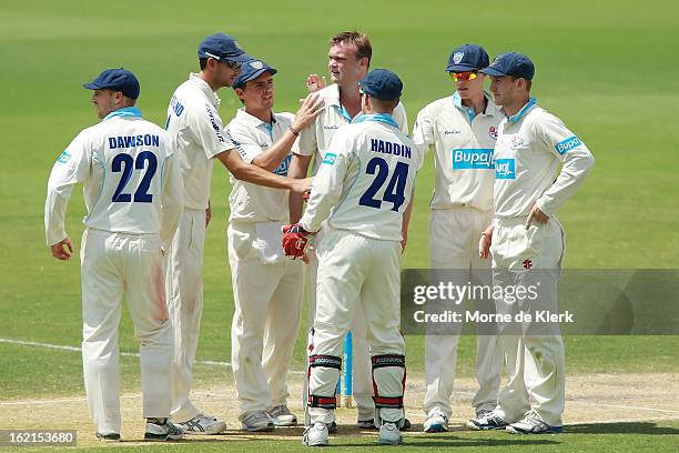 Doug Bollinger of the Blues is congratulated by teammates after he got a wicket during day two of the Sheffield Shield match between the South...