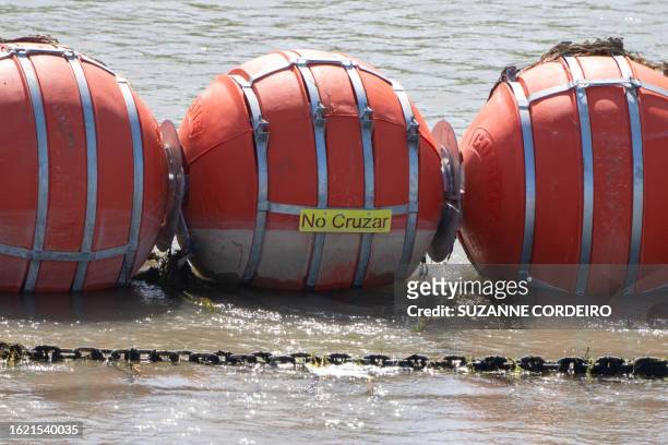 Buoys are pictured placed along the Rio Grande border with Mexico in Eagle Pass, Texas, on August 24 to prevent migrants from entering the US. The...