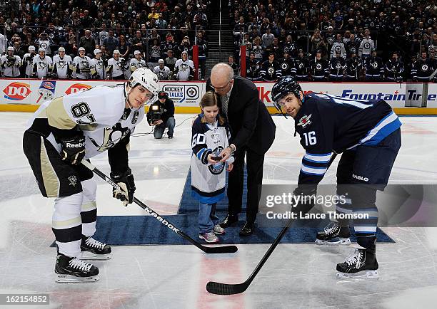 Sidney Crosby of the Pittsburgh Penguins and Andrew Ladd of the Winnipeg Jets smile as they wait for the ceremonial puck drop at the MTS Centre on...