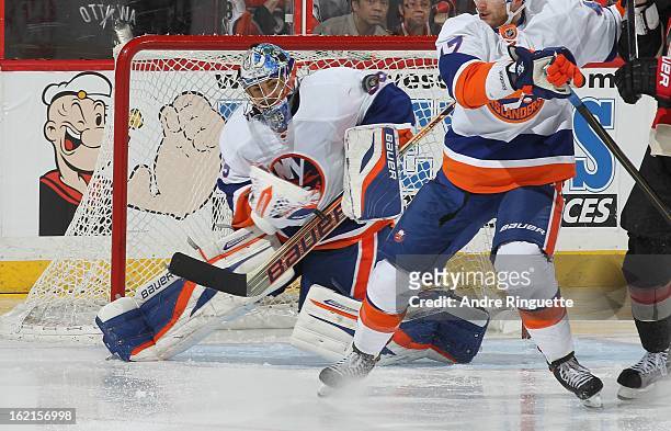 Rick DiPietro of the New York Islanders makes a shoulder save against the Ottawa Senators on February 19, 2013 at Scotiabank Place in Ottawa,...