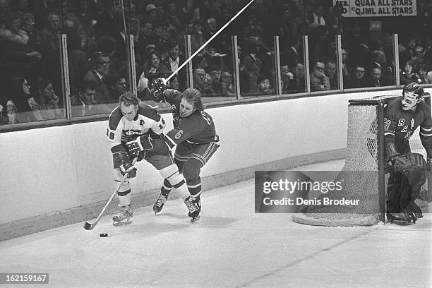 Henri Richard of the Montreal Canadiens skates behind the net against Glen Sather of the New York Rangers as goalie Gilles Villemure fo the Rangers...