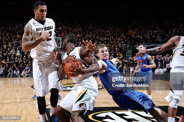 Keion Bell and Jabari Brown of the Missouri Tigers defend against Erik Murphy of the Florida Gators during the game at Mizzou Arena on February 19,...