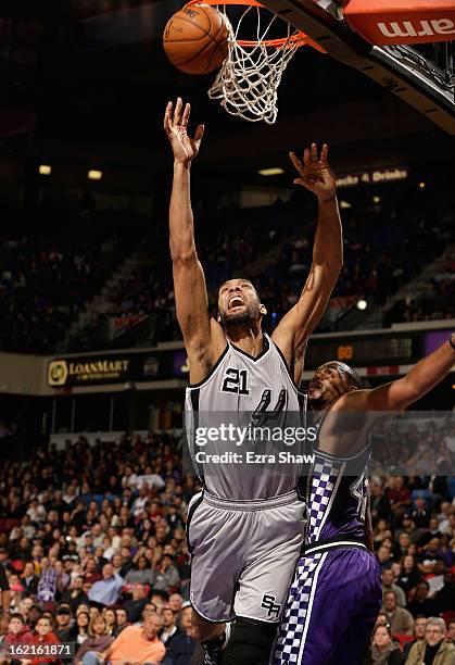 Tim Duncan of the San Antonio Spurs is fouled by Chuck Hayes of the Sacramento Kings at Sleep Train Arena on February 19, 2013 in Sacramento,...