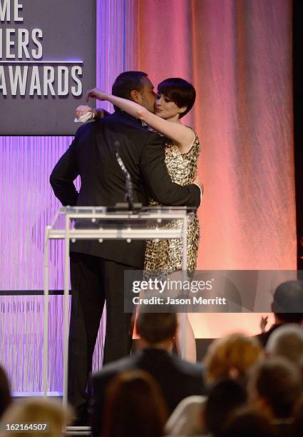 Actor Russell Crowe presents the Lacoste Spotlight Award to actress Anne Hathaway during the 15th Annual Costume Designers Guild Awards with...