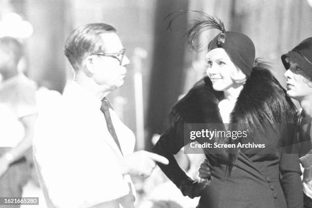 Marilyn Monroe and Tony Curtis talking with Joe E Brown from the 1959 Billy Wilder comedy 'Some Like it Hot'.