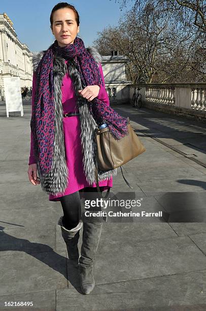 Natalia Dombrovska wears a silver fox fur gilet, a Louis Vuitton scarf, and Diane von Furstenberg dress accessorised by a Forever 21 belt, Wolford...