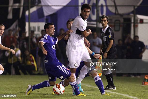 Juan Carlos Ferreyra of Olimpia and Paulo Garces of Universidad de Chile fight for the ball during a match between Olimpia and Universidad de Chile...