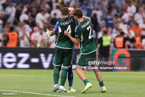Alberto Brignoli of Panathinaikos FC is congratulated by team mates Ruben Perez and Georgios Vagiannidis following the penalty shoot out victory in...