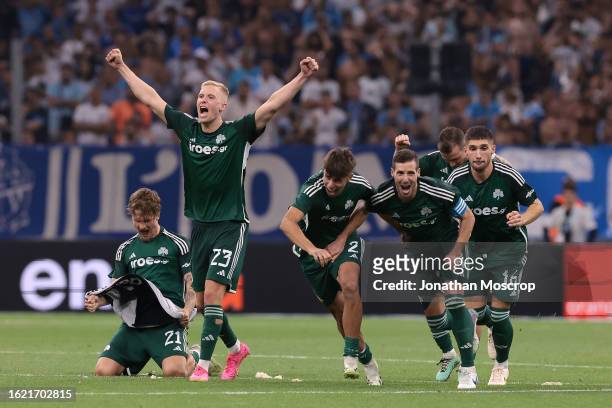 Panathinaikos FC players celebrate as team mate Filip Mladenovic scores the decisive penalty in the shoot out following the UEFA Champions League...