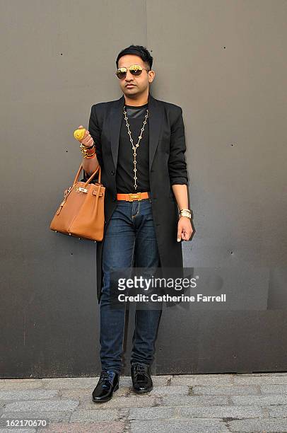 Amar Hussain Pakastani stylist wears an Alexander McQueen first collection coat, skinny jeans from the High Street, accessorised with Michael Kors...
