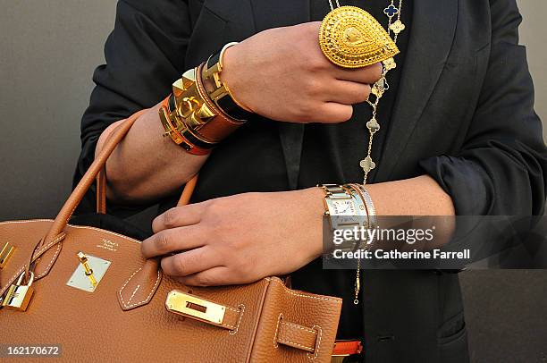 Amar Hussain Pakastani stylist wearing an Alexandrer Mc Queen First Collection coat,accessorised with Michael Kors sunglasses,Van Cleef and Arepels...