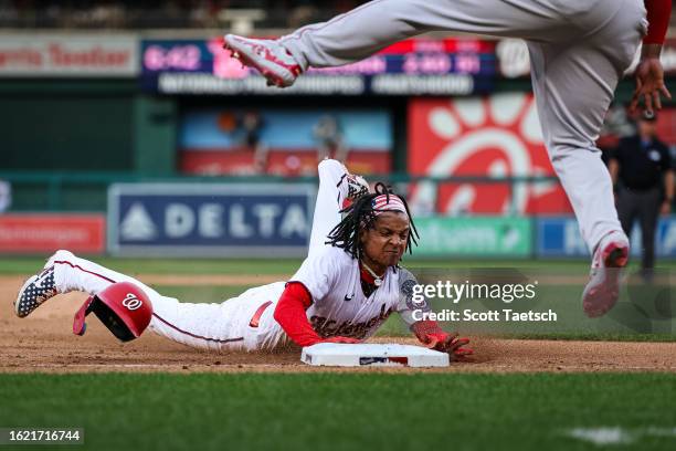 Abrams of the Washington Nationals slides to steal third base against the Boston Red Sox during the eighth inning at Nationals Park on August 17,...