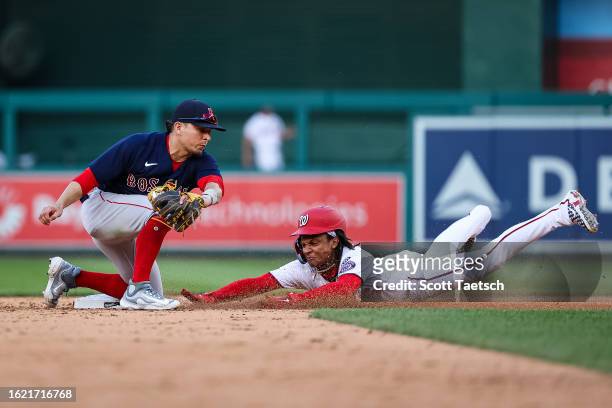 Abrams of the Washington Nationals slides to steal second base in front of Luis Urias of the Boston Red Sox during the eighth inning at Nationals...