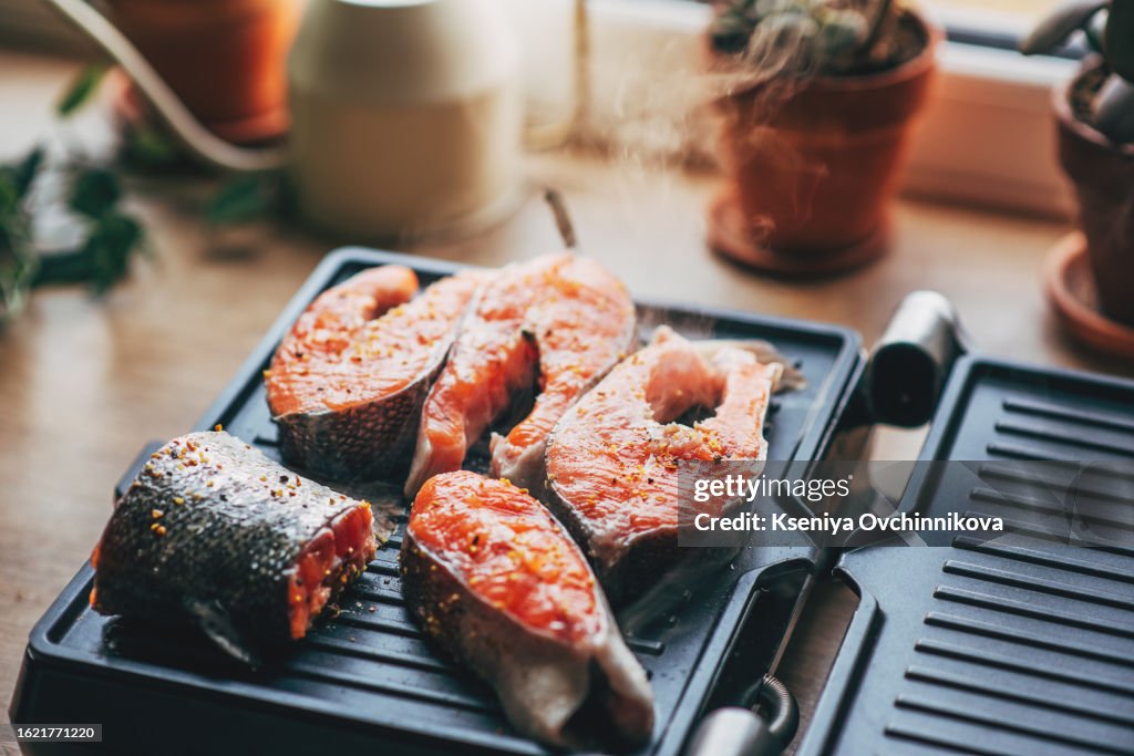 Delicious Salmon Filets on a grill topped with lemon slices
