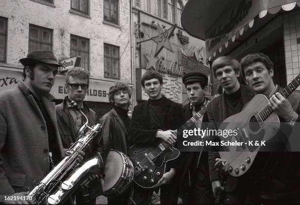 Circa 1965: English singer and guitarist Tony Sheridan posed far right with his band outside the Star Club in Hamburg, Germany circa 1965.