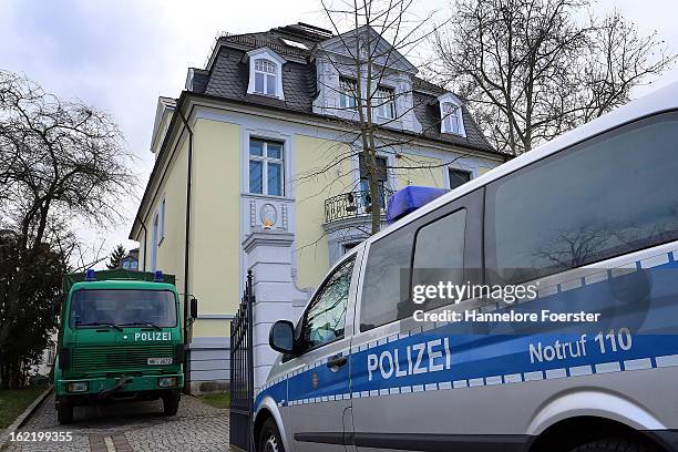 Police cars stand outside the headquarters of the S&K investment group the day after police raided the company's offices on February 20, 2013 in...