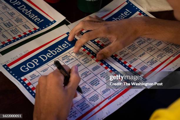 Attendees play bingo during a watch party, hosted by Americans for Prosperity New Hampshire, for the first Republican Presidential Primary debate at...