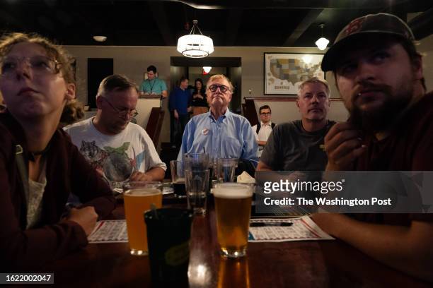 Norm Olsen of Portsmouth watches the debate during a watch party, hosted by Americans for Prosperity New Hampshire, for the first Republican...