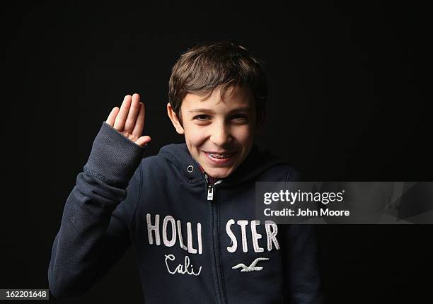 Fifth grader Theodore Poncet born in France, holds his hand as for the oath of allegiance while awaiting his American citizenship certificate at the...