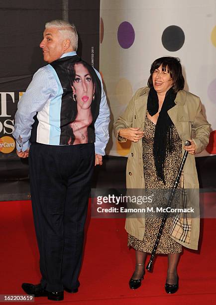 Mitch Winehouse wears a tribute to late daughter, Amy Winehouse, with mother Janis Winehouse at the Brit Awards 2013 at the 02 Arena on February 20,...