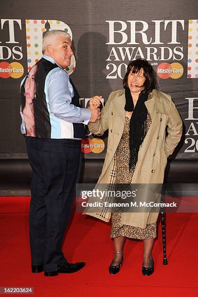 Mitch Winehouse wears a tribute to late daughter, Amy Winehouse, with mother Janis Winehouse at the Brit Awards 2013 at the 02 Arena on February 20,...