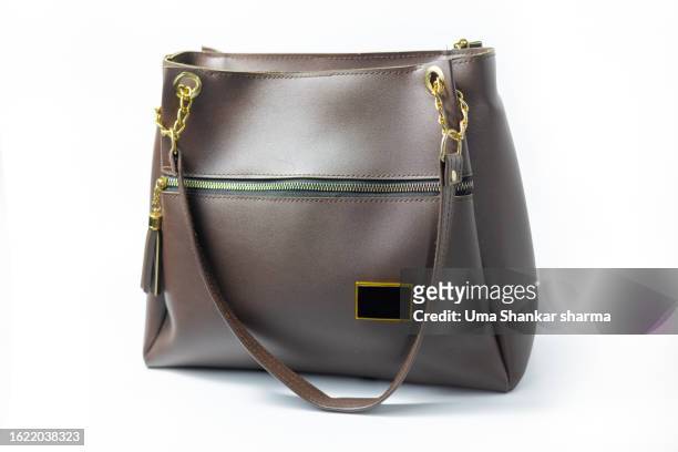 brown leather women's handbag on white background - box purse stock-fotos und bilder