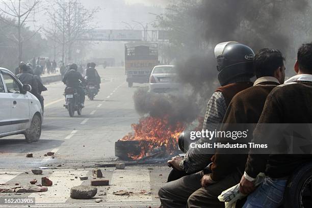 Tyre burned by mob to restrict the traffic during 48 hours nationwide strike called by eleven major Trade Unions to protest Government’s economic and...