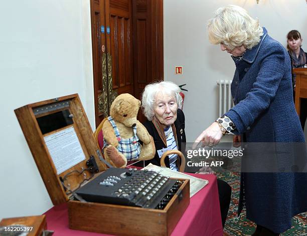 Britain's Camilla, Duchess of Cornwall looks at an Enigma Machine alongside Code Breaker Eileen Johnson , during a reception held at The Mansion...