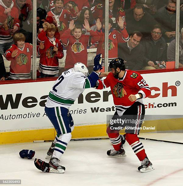 Children cheer as Brandon Bollig of the Chicago Blackhawks fights with Dale Weise of the Vancouver Canucks at the United Center on February 19, 2013...