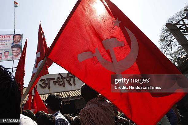 Trade union activists carrying Communist party flag participate in march in support of 48 hours strike called by 11 national trade unions against the...