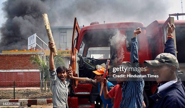 Vehicles set fire by the angry mob as they protest during the two-day nationwide strike called by various trade unions to protest against...