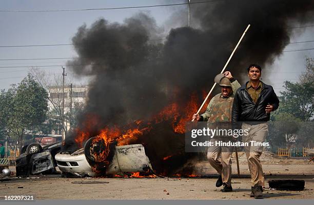 Vehicles set fire by the angry mob as they protest during the two-day nationwide strike called by various trade unions to protest against...