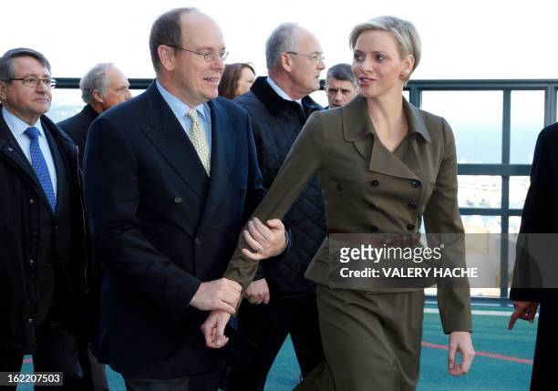 Prince Albert II of Monaco and Princess Charlene visit the new "Lycee Technique et Hotelier de Monaco" on February 20, 2013 in Monaco. AFP PHOTO /...