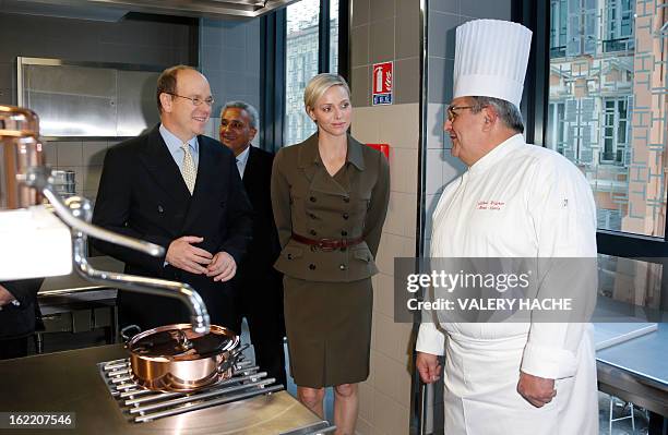 Prince Albert II of Monaco and Princess Charlene speak with chef Albert Wagner during their visit to the new "Lycee Technique et Hotelier de Monaco"...