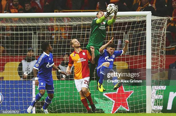 Klaas-Jan Huntelaar of Schalke is challenged by goalkeeper Fernando Muslera and Semih Kaya of Galatasaray during the UEFA Champions League Round of...