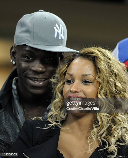 Mario Balotelli and Fanny Neguesha attend the UEFA Champions League Round of 16 first leg match between AC Milan and Barcelona at San Siro Stadium on...