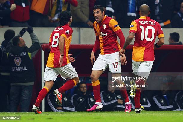 Burak Yilmaz of Galatasaray celebrates his team's first goal with team mates Selcuk Inan and Felipe Melo during the UEFA Champions League Round of 16...